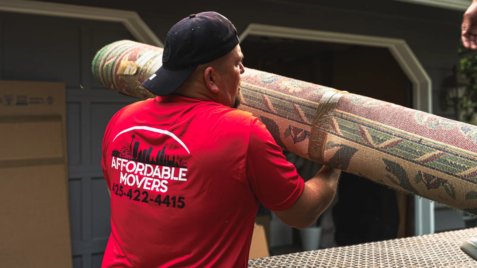 Affordable Movers crew carrying protected furniture.