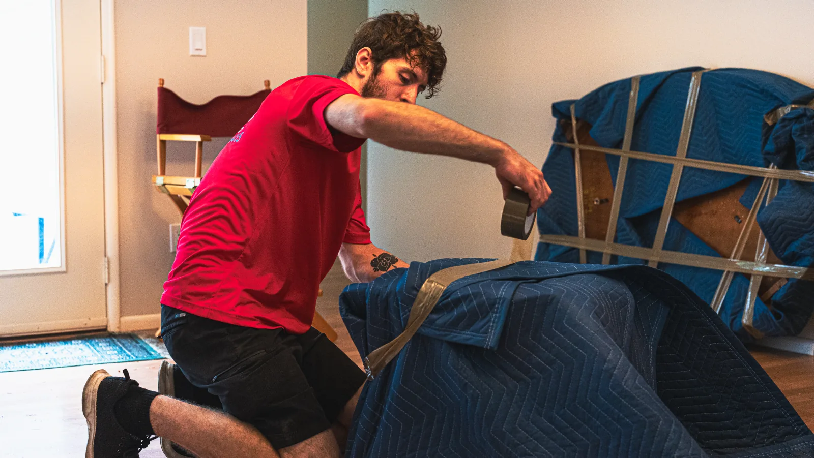 Affordable Movers team member protecting furniture for a move.