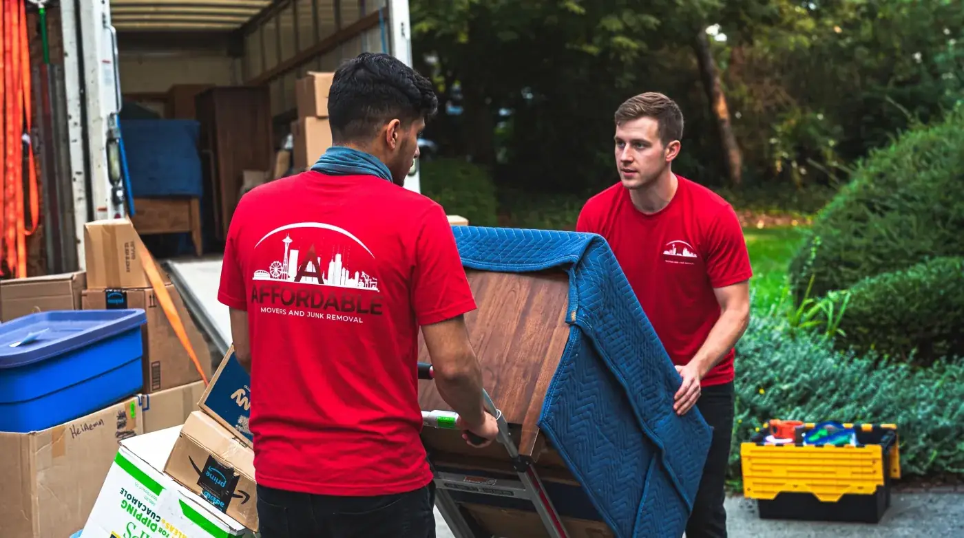 Affordable Movers crew moving protected furniture.