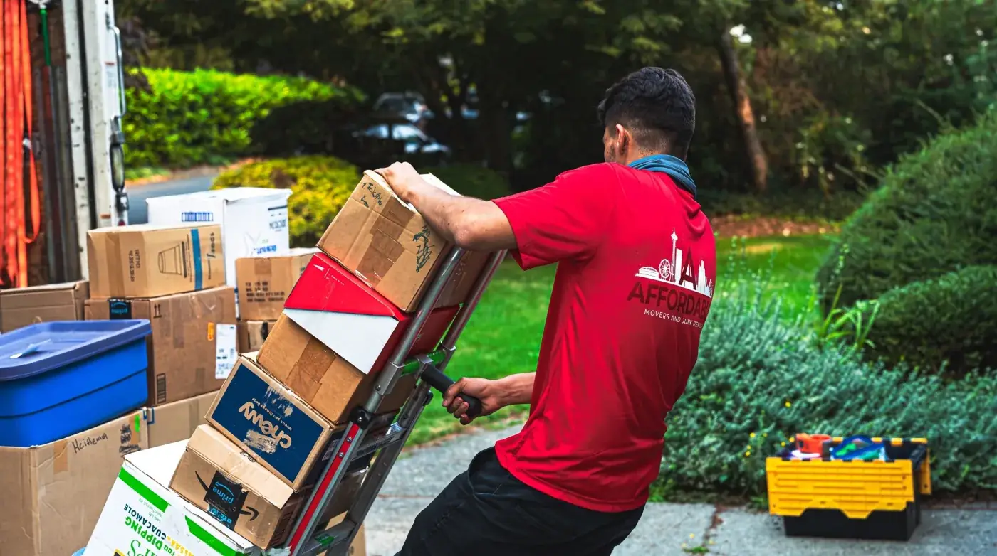 Affordable Movers team loading boxes with a hand truck.