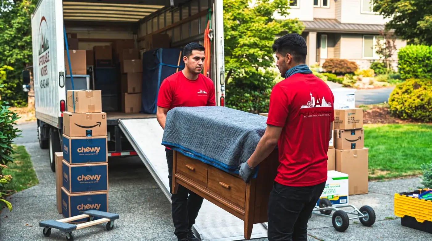 Affordable Movers crew moving furniture from a home.